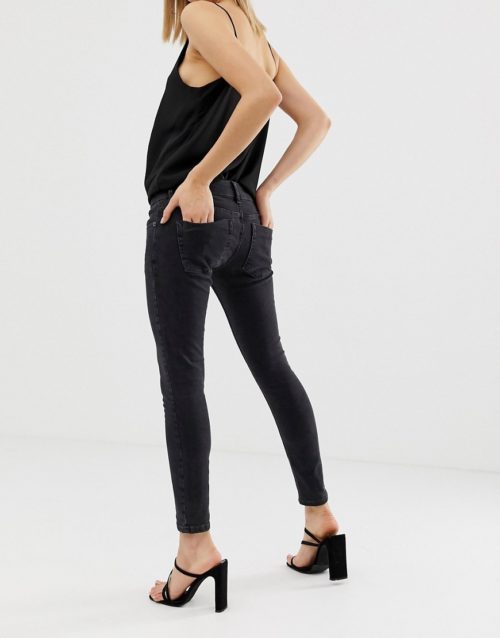 ASOS DESIGN Petite extreme low rise skinny jeans in washed black
