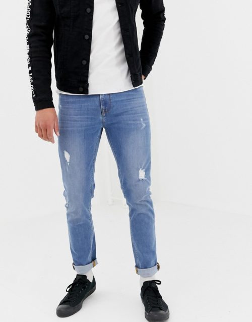 ASOS DESIGN skinny jeans in light wash blue with abrasions